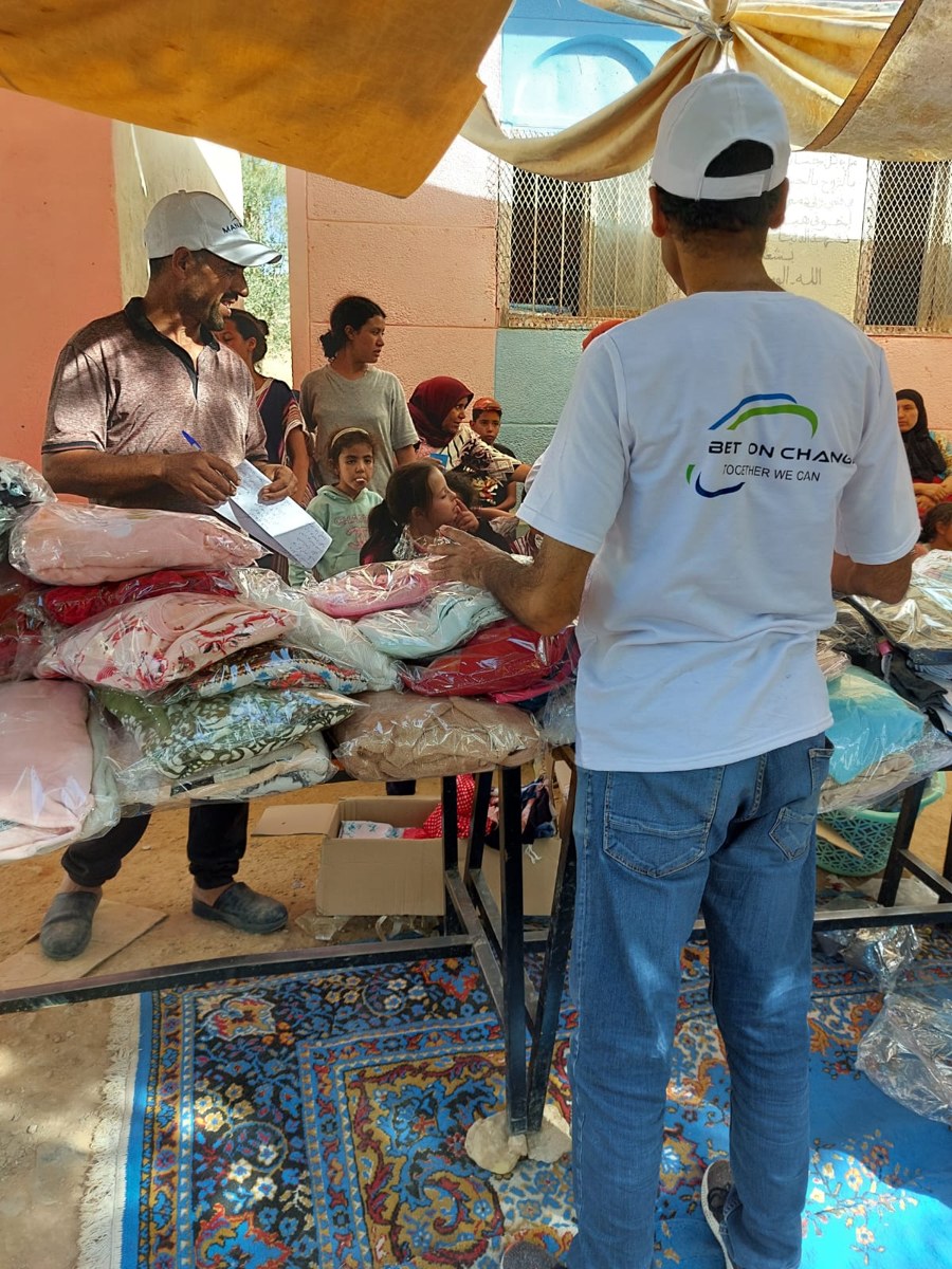 Volunteer in Bet On Change t‑shirt during field work